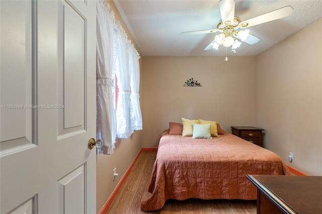 bedroom featuring hardwood / wood-style floors and ceiling fan