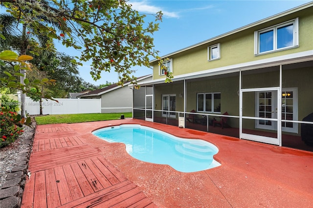 view of pool featuring a deck and a sunroom