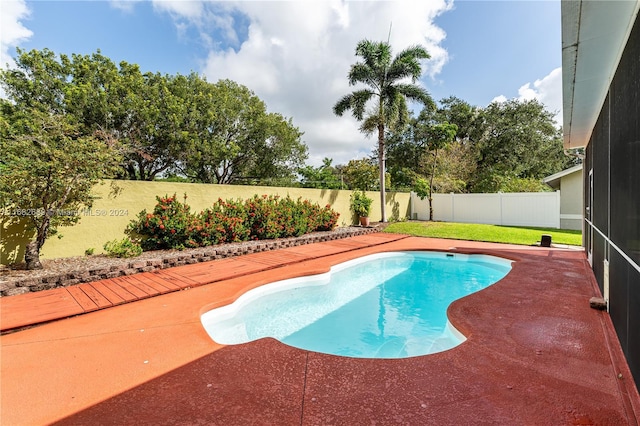 view of pool featuring a yard and a patio