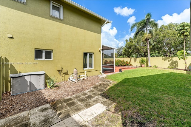 rear view of property featuring a yard and a patio area