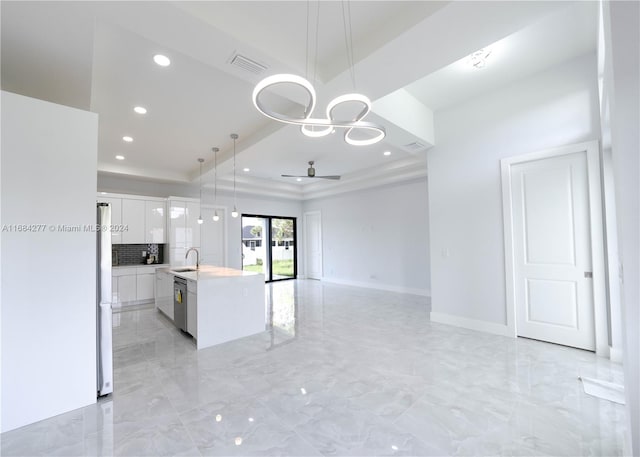 kitchen with a kitchen island with sink, stainless steel appliances, decorative light fixtures, white cabinetry, and ceiling fan