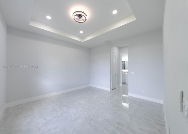 empty room with a tray ceiling