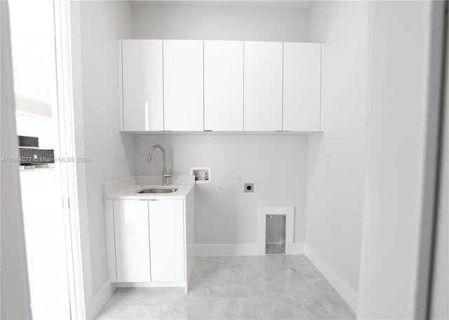 laundry room with hookup for an electric dryer, sink, hookup for a washing machine, and cabinets