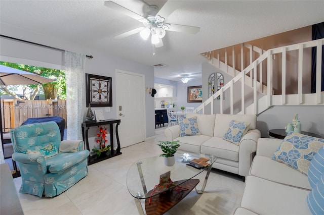 living room featuring a textured ceiling and ceiling fan