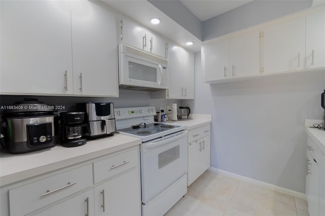 kitchen with white cabinets, white appliances, and light tile patterned floors