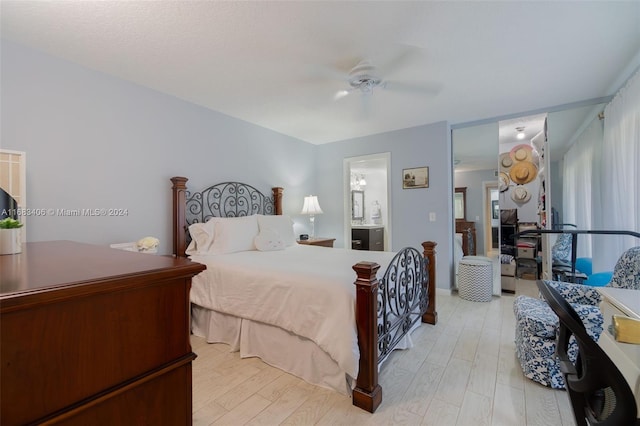 bedroom with ensuite bath, light hardwood / wood-style floors, and ceiling fan