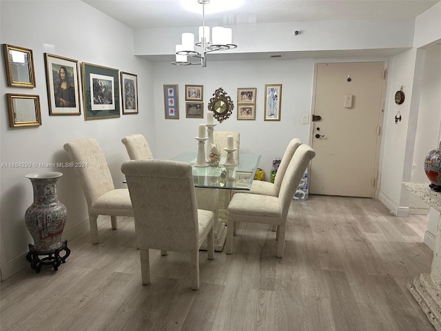 dining space featuring a chandelier and light wood-type flooring