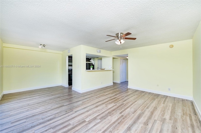 unfurnished living room with light hardwood / wood-style flooring, a textured ceiling, and ceiling fan