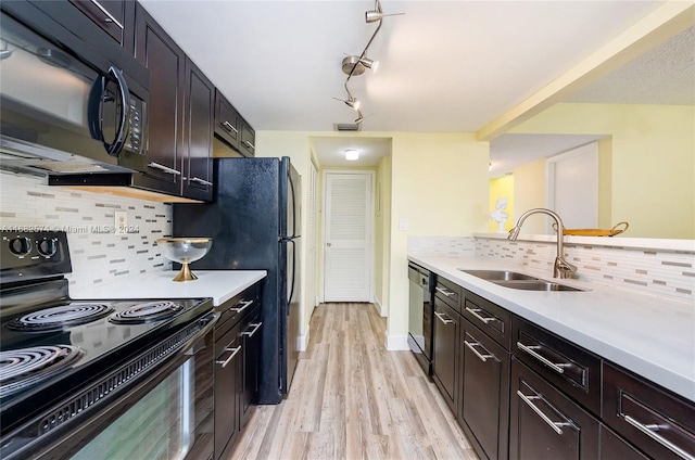 kitchen with dark brown cabinets, sink, black appliances, light hardwood / wood-style floors, and tasteful backsplash