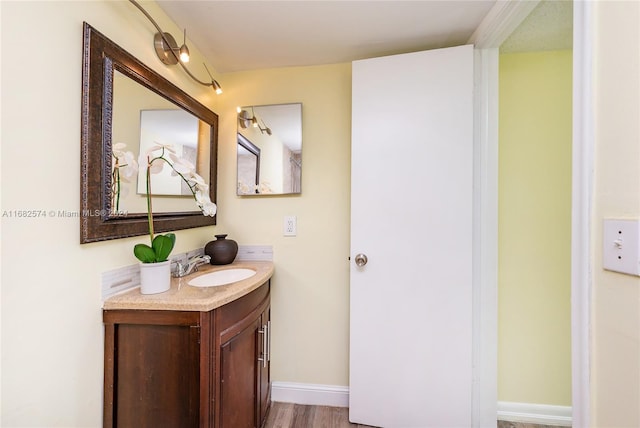 bathroom featuring vanity and hardwood / wood-style floors