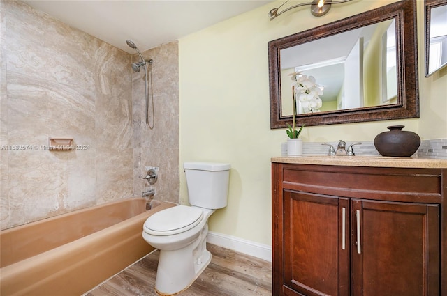 full bathroom featuring vanity, toilet, hardwood / wood-style floors, and tiled shower / bath