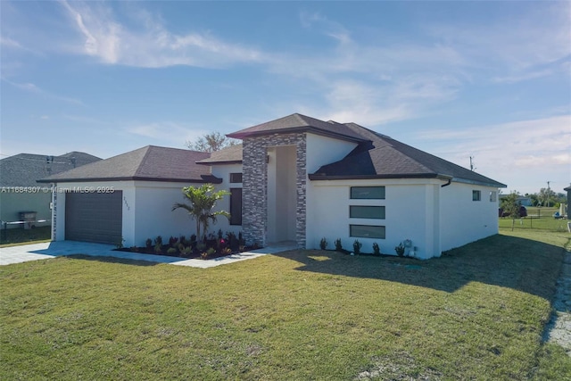 view of front of home with a front yard and a garage