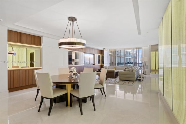 dining space with a chandelier and light tile patterned floors