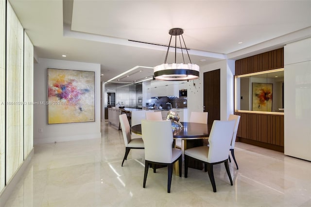 dining area featuring a notable chandelier