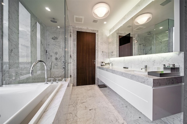 bathroom with vanity and independent shower and bath