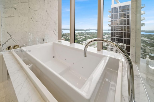 bathroom featuring a water view and a bathing tub