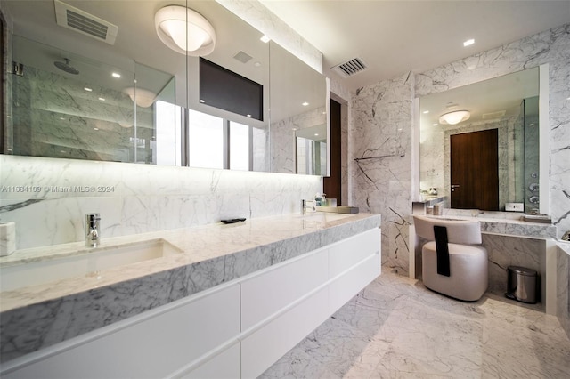 bathroom with vanity, walk in shower, and tile walls