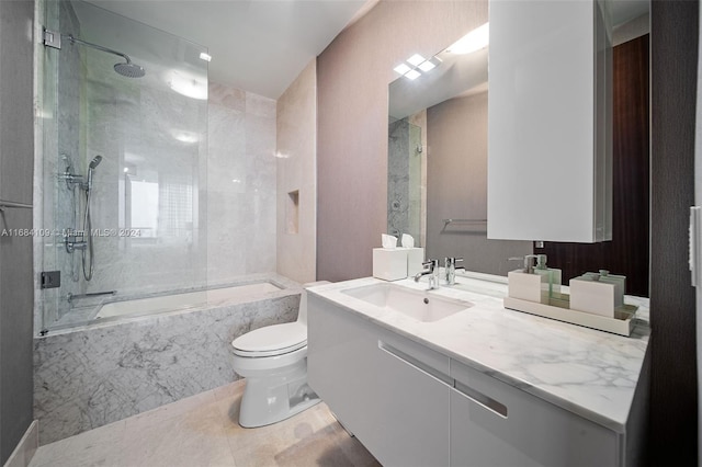 full bathroom featuring tiled shower / bath, vanity, toilet, and tile patterned floors