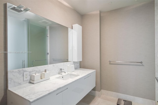 bathroom with vanity, tasteful backsplash, and tile patterned floors