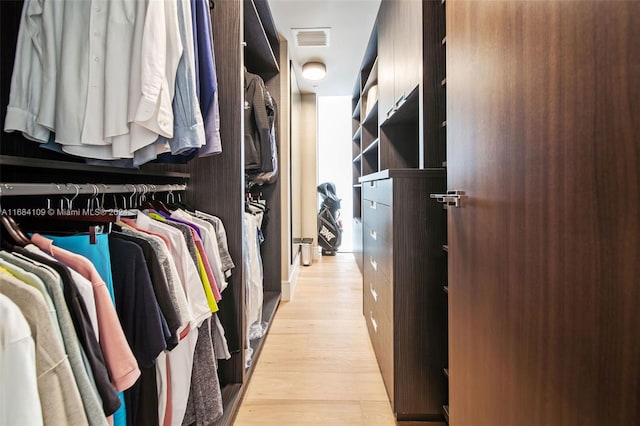 walk in closet featuring light hardwood / wood-style floors