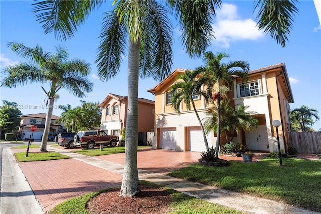 view of front of property featuring a garage and a front lawn