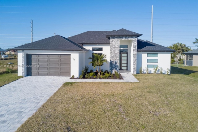 prairie-style home with a garage and a front lawn