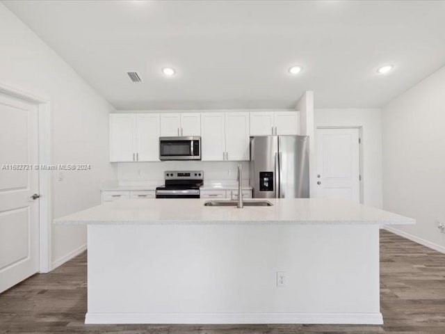 kitchen featuring white cabinetry, appliances with stainless steel finishes, sink, and a center island with sink