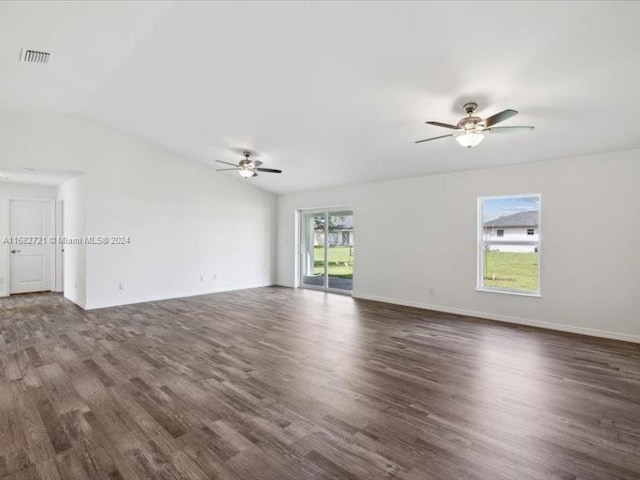 spare room featuring lofted ceiling, dark hardwood / wood-style floors, and ceiling fan