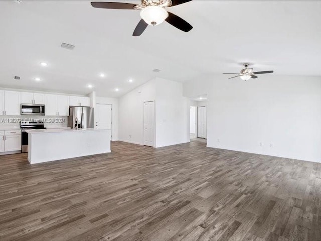 unfurnished living room featuring lofted ceiling, dark hardwood / wood-style floors, and ceiling fan