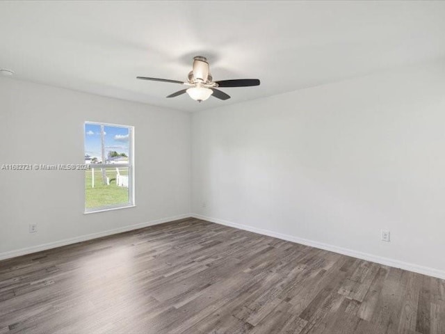 spare room with ceiling fan and dark hardwood / wood-style flooring