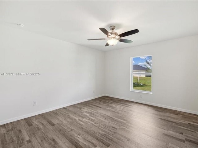 spare room featuring ceiling fan and dark hardwood / wood-style flooring