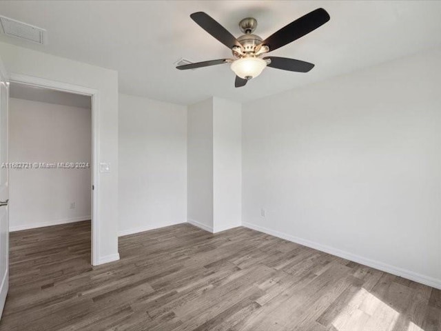 unfurnished room with wood-type flooring and ceiling fan