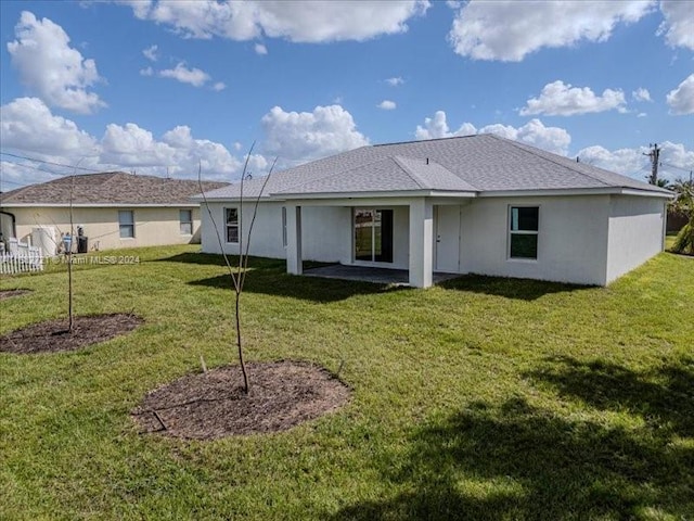 back of house with a lawn