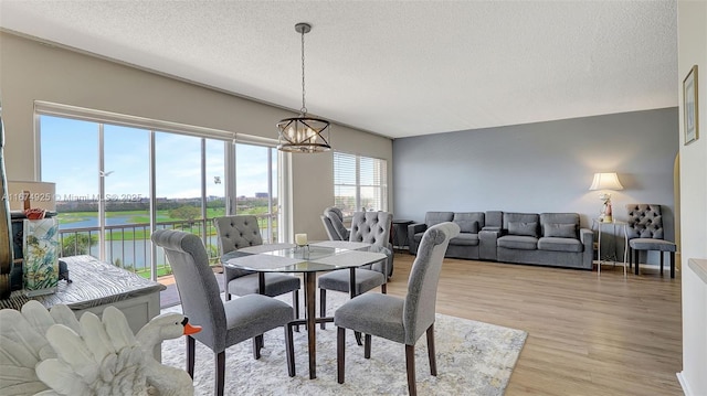 300 Diplomat Pkwy Unit 817, Hallandale Beach, FL 33009 - dining room featuring a chandelier, a textured ceiling, and light wood-type flooring