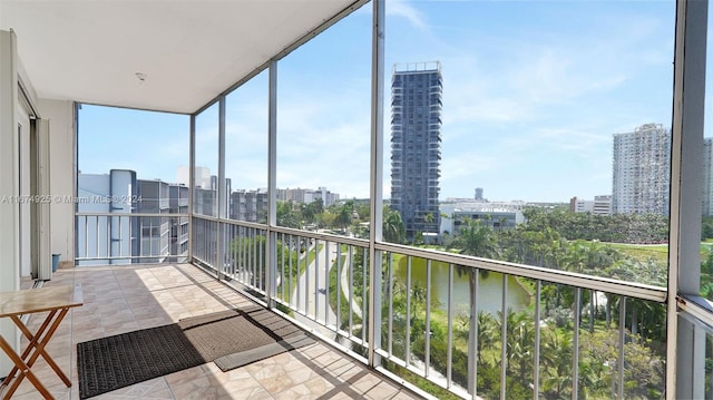 unfurnished sunroom featuring a water view and a healthy amount of sunlight