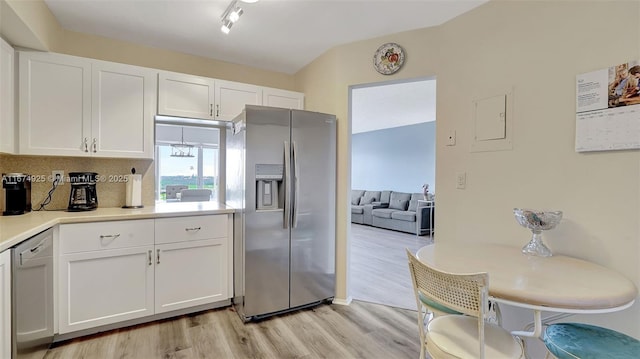 kitchen featuring light wood-type flooring, white cabinetry, stainless steel appliances, and light countertops