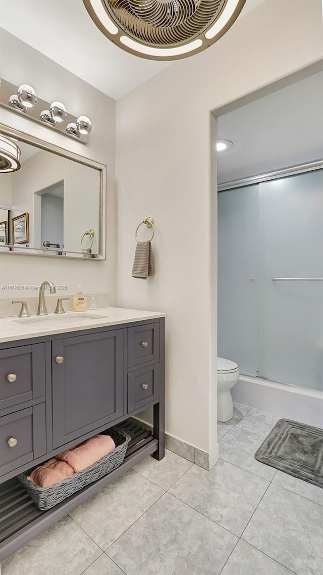 bathroom featuring a shower with door, visible vents, toilet, vanity, and tile patterned flooring