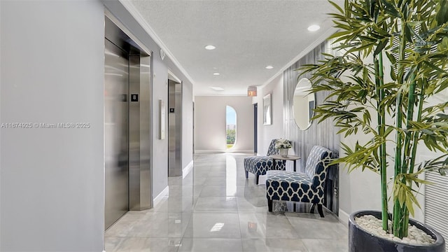 corridor featuring crown molding, recessed lighting, elevator, a textured ceiling, and baseboards