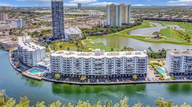 birds eye view of property with view of golf course, a water view, and a city view