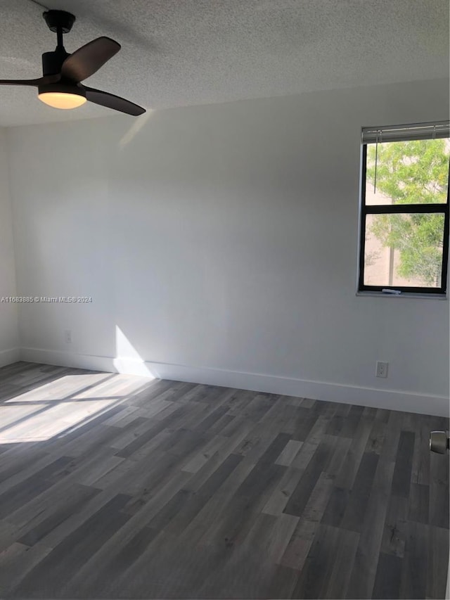 unfurnished room with a textured ceiling, ceiling fan, and dark hardwood / wood-style floors