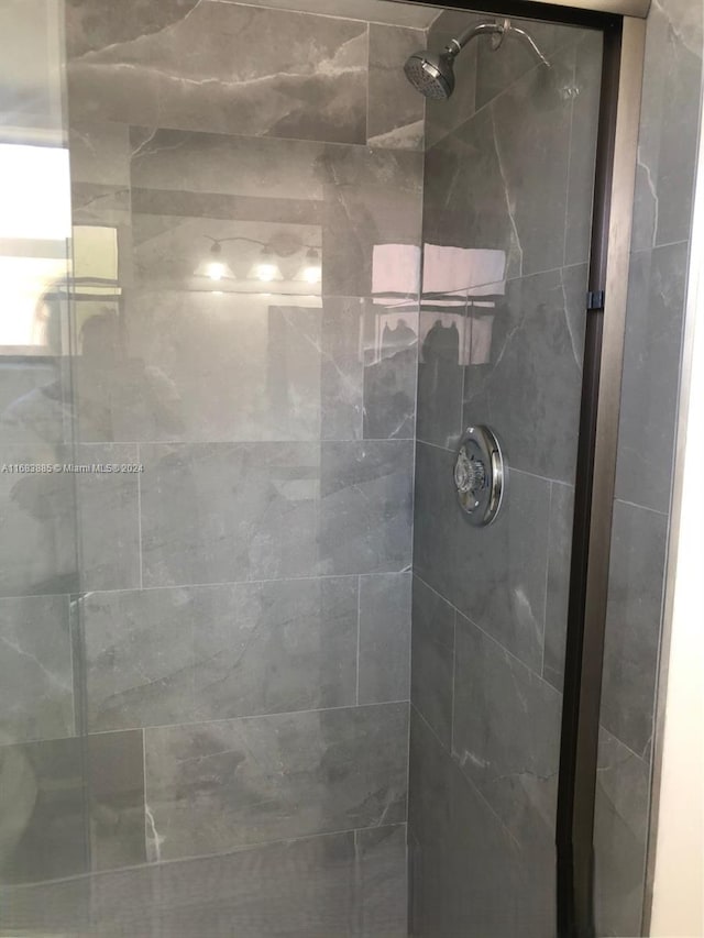 bathroom with a shower with shower door