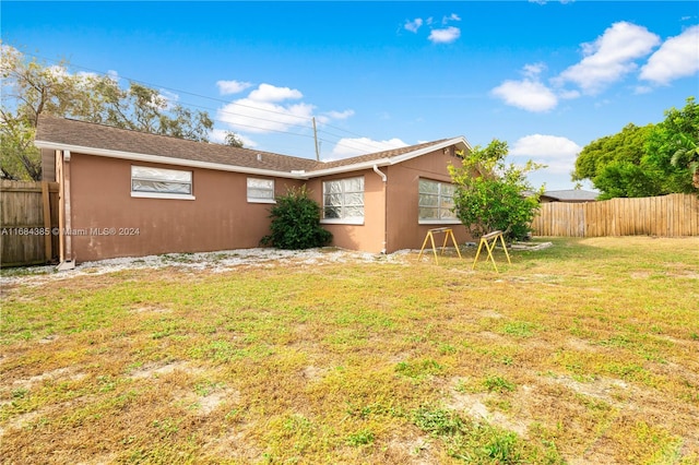 back of house featuring a yard