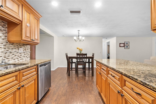 kitchen featuring dishwasher, stone countertops, dark wood-type flooring, hanging light fixtures, and an inviting chandelier