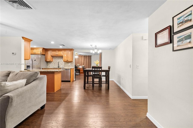 living room with dark hardwood / wood-style floors, a chandelier, and sink