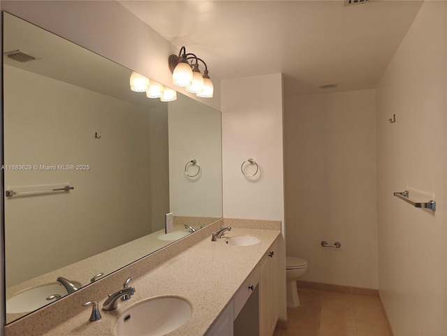 bathroom featuring tile patterned floors, vanity, and toilet