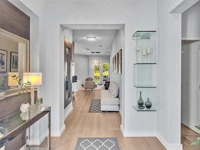 corridor featuring french doors and light wood-type flooring