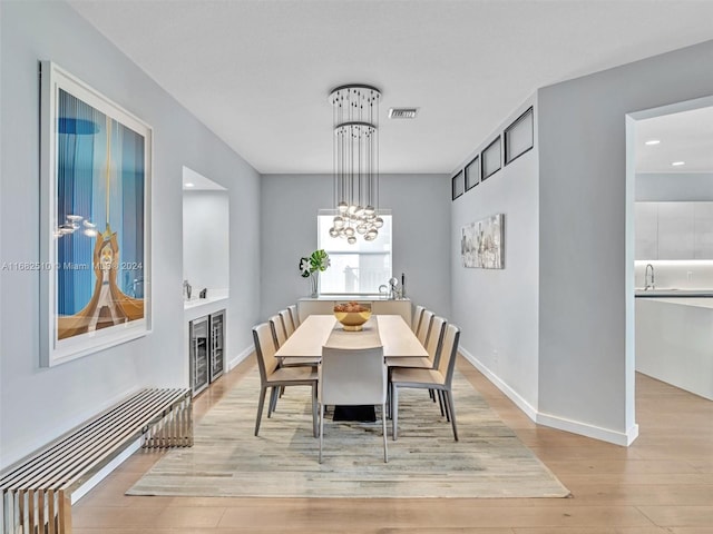 dining room with sink and light hardwood / wood-style flooring