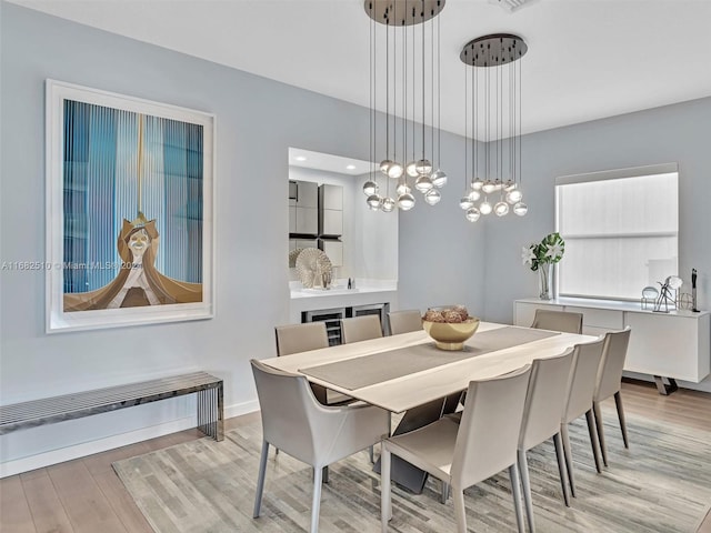 dining room with light hardwood / wood-style flooring and plenty of natural light