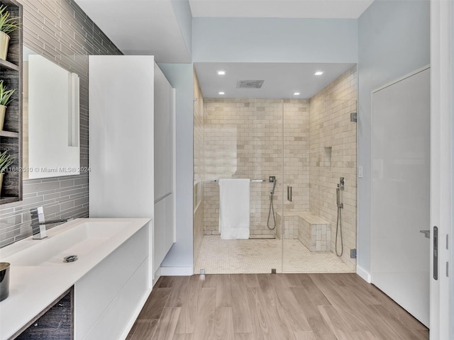 bathroom featuring vanity, hardwood / wood-style flooring, and an enclosed shower