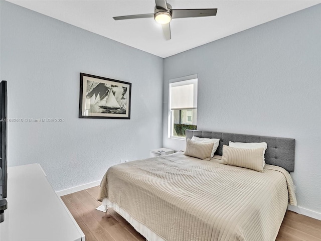 bedroom with wood-type flooring and ceiling fan